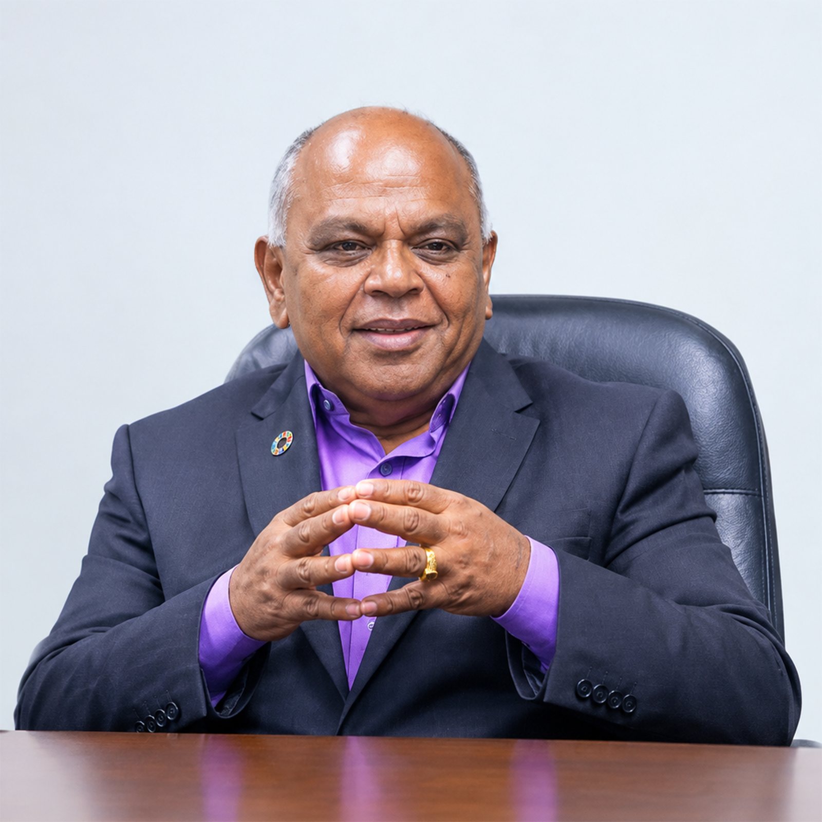 Satya Brata Das, seated at a boardroom table